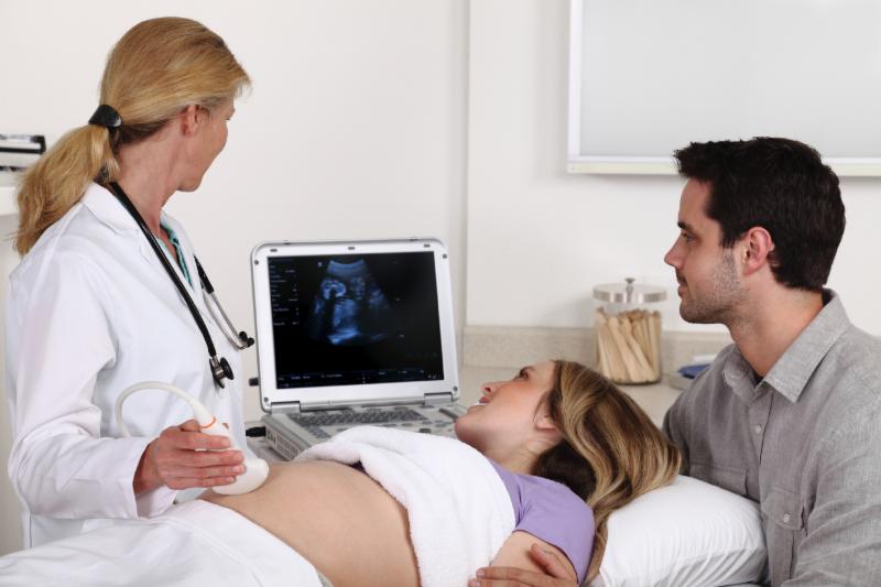 Father, mother, and doctor at ultrasound appointment